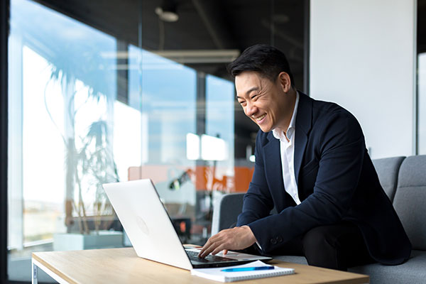 An executive excitedly reads an email